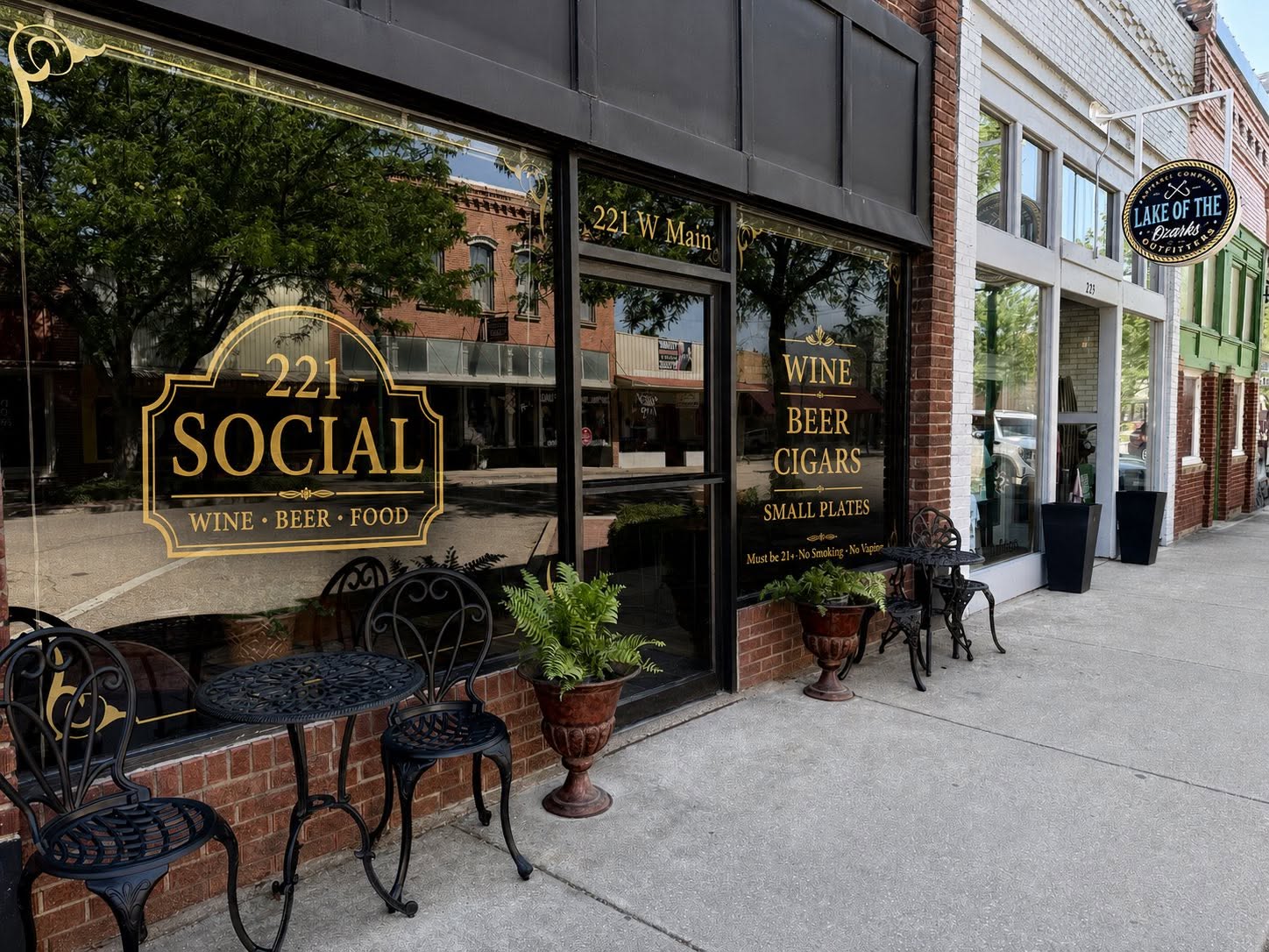 The 221 Social storefront at 221 W Main with bistro tables outside