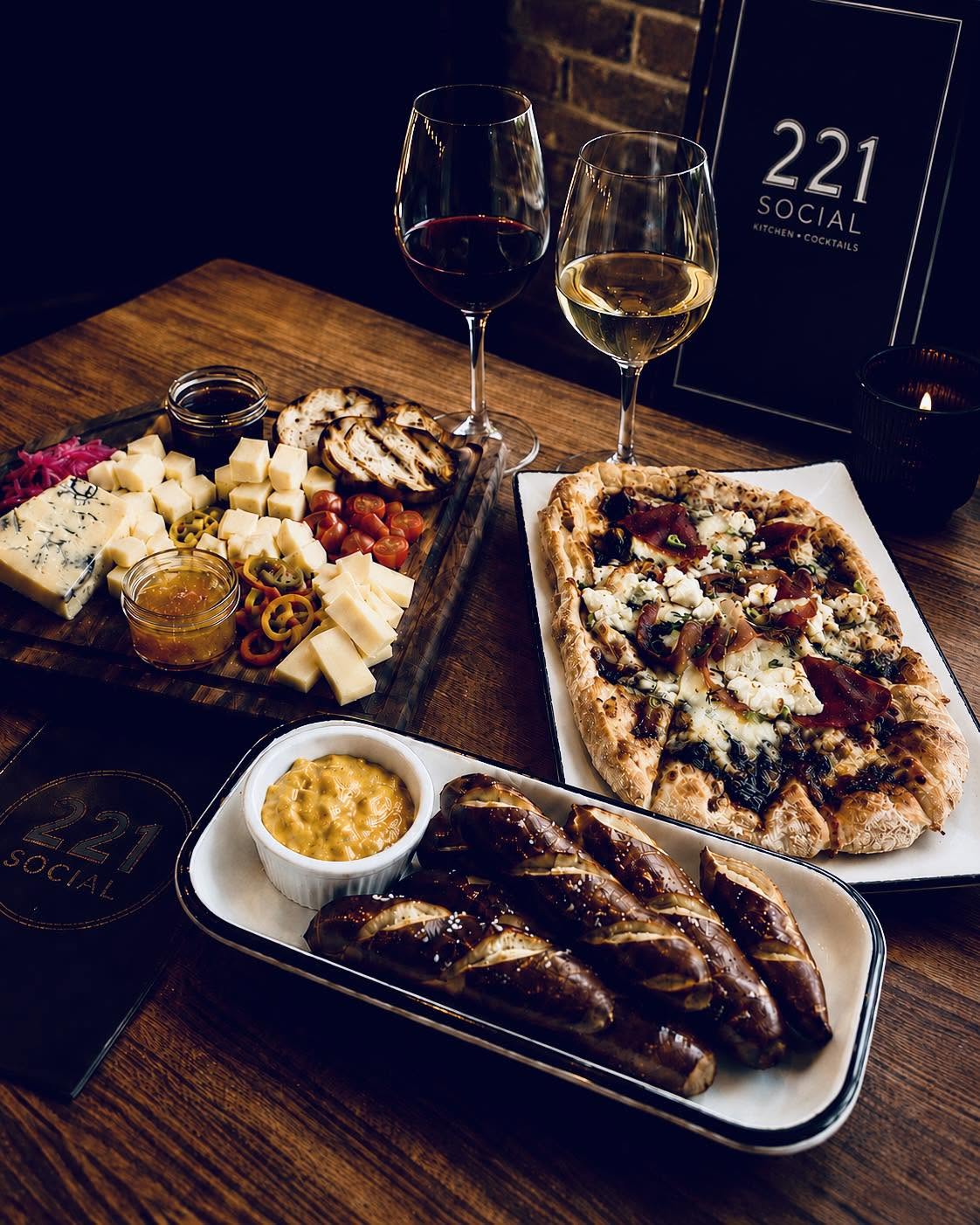 Flatbread, pretzel bites with beer cheese and a cheese board with red and white wine