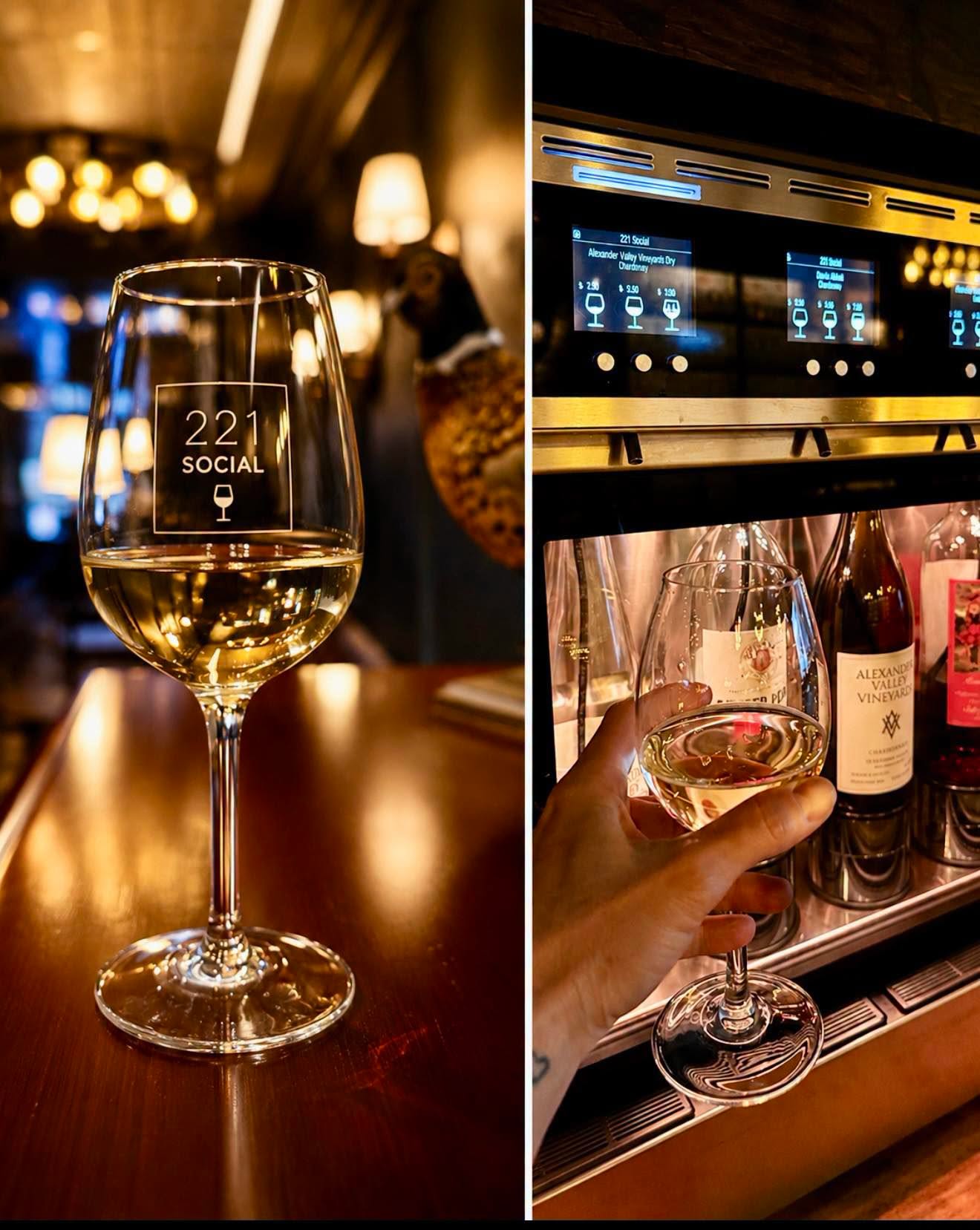 A branded 221 Social wine glass beside the tasting dispenser